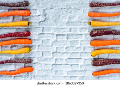 Baby Rainbow Carrots On A White Background With Copy Space - Overhead View