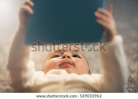 Baby reading a book on back