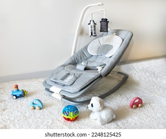 Baby rocker and toys in baby playroom 