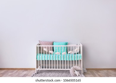 Baby Room Interior With Crib Near Wall