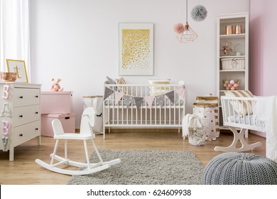 Baby room in scandinavian style with rocking horse, white cot