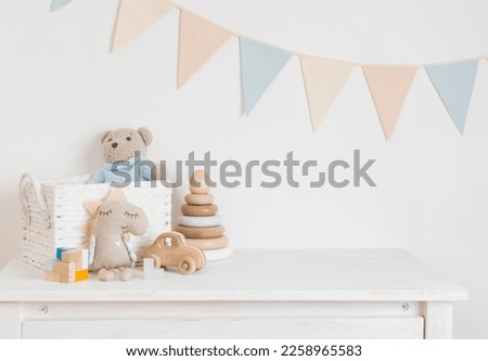 Baby room with wooden toys, plush animals and pennant garland