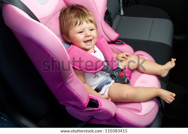 baby in a\
safety car seat. Safety and\
security