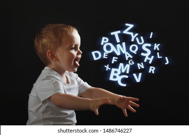 Baby Says, The Concept Of Problems With Dyslexia And Dysgraphia. A Child Learns To Speak, A Boy On A Black Background, A Cloud Of Chaotic Letters On The Right