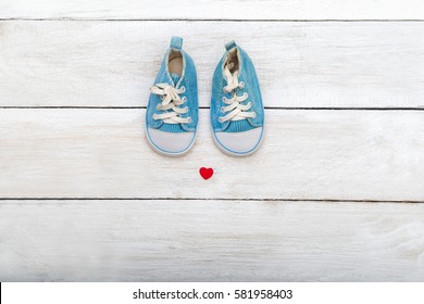 Baby shoes on wooden background. flat lay