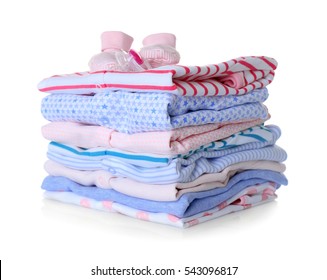 Baby Shoes, Pile Of Clothes And Dummy On White Background