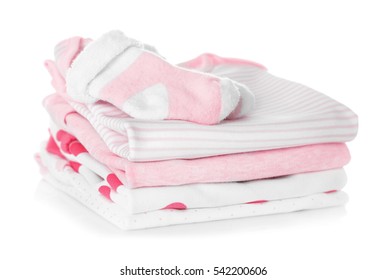 Baby Shoes And Pile Of Clothes On White Background