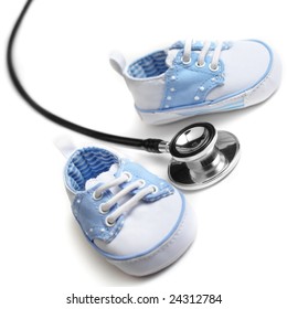 Baby Shoes With Stethascope Against A White Background.