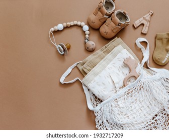Baby shower concept. Newborn baby accessories on brown background, Top view, flat lay.