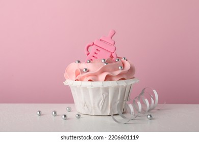 Baby Shower Cupcake With Topper On White Table Against Pink Background