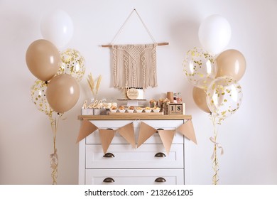 Baby Shower Party. Different Delicious Treats On White Wooden Chest Of Drawers And Decor Near Light Wall