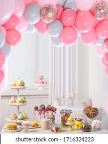Baby Shower Party For Girl. Tasty Treats On Table In Room Decorated With Balloons