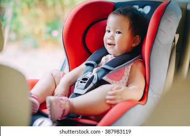 A Baby Sit In The Car Seat For Safety.