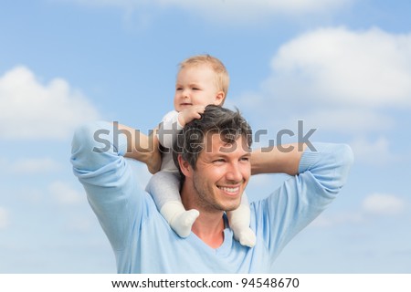 baby sitting on father