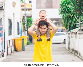 Baby Is Sitting On Neck Of Father. They Are So Happy When They Play Together