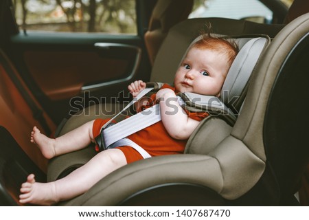 Baby sitting in safety rear-facing car seat family lifestyle vacation road trip child security transportation 