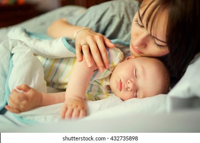 Baby Sleeping In Bed With Mother. Care.