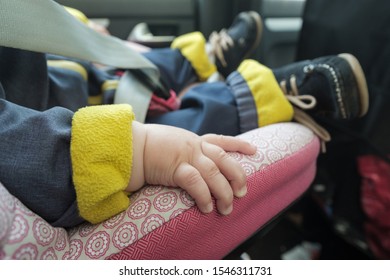 Baby Sleeping In Car Seat. No Face. Focus On Hand