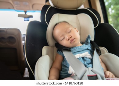 Baby sleeping in child car seat.