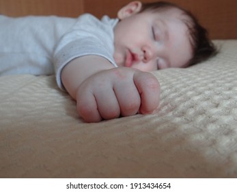 Baby Sleeps On The Bed