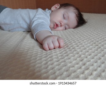 baby sleeps on the bed