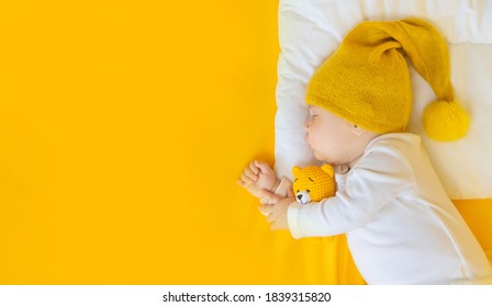 Baby Sleeps On A Yellow Background. Selective Focus. People.