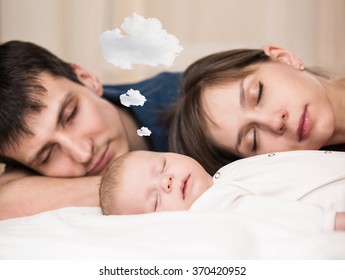 Baby Sleeps  With Tired Parents