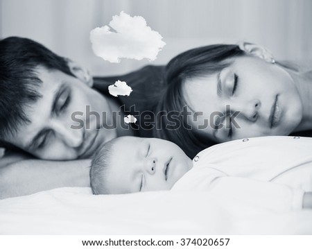 Similar – Mother reading book to her sons in the bed