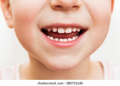 Baby Smile Close. White Teeth Of A Child Isolated On A White Background
