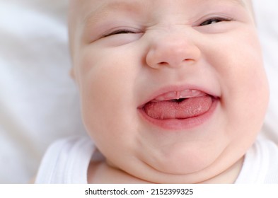 Baby Smiling With A Toothless Mouth Close-up. Infant Laughing. Children Healthcare