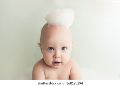 Baby With Soap Foam Or Shampoo On His Head