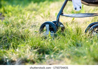 Baby Stroller Close Up Wheels In Green Grass