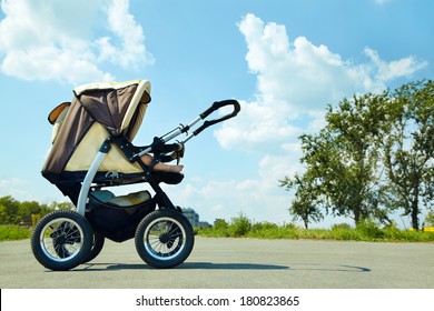 Baby Stroller On A Walk In The Park Summer Day