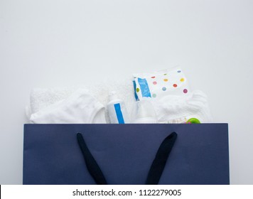 Baby Stuff In The Blue Paper Shopping Bag