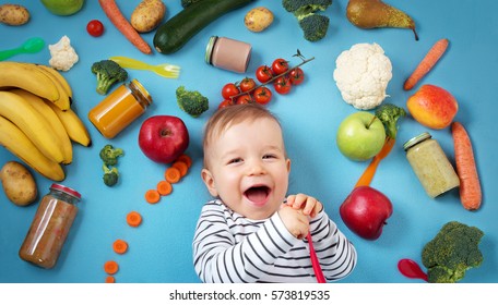 Baby Surrounded With Fruits And Vegetables On Blue Blanket, Healthy Child Nutrition