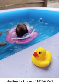 Baby Swiming In The Poolbag Behind Ducktoy
