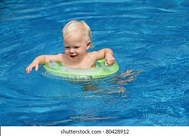 Baby Swimming In The Blue Pool Water