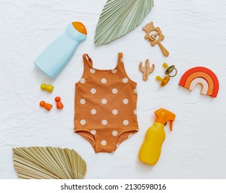 Baby Swimsuit, Beach Accessories And Sunscreen Cream. LSun Lotion For Children. Concept Ultraviolet Protection Product, Summer Children Cosmetics.