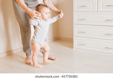 Baby Taking First Steps With Mother Help