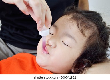 Baby Taking Medicine With Dropper