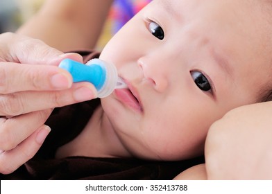 Baby Taking Medicine With Dropper