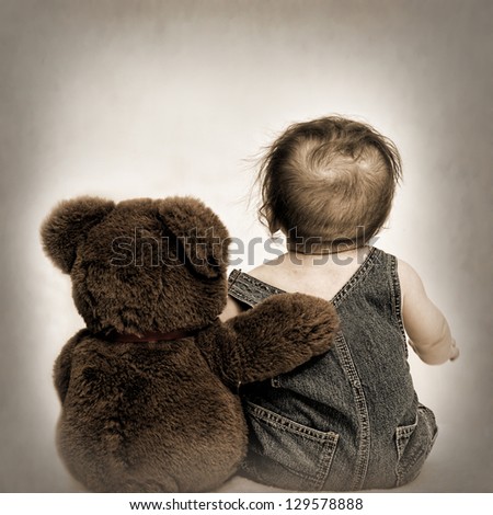 Baby and Teddy Bear sitting with backs to us - concept best friends