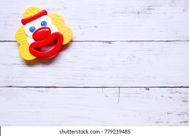 Baby Teether Infant Teething Ring.Colorful Baby Rattles Toy Joker Shape.Copy Space For Text Or Logo.