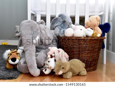 Baby toddler bedroom with basket of stuffed toys 