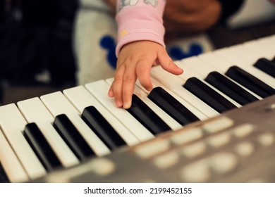 Baby Toddler Hand On Piano. Music Lessons For Children. Art Therapy Concept.