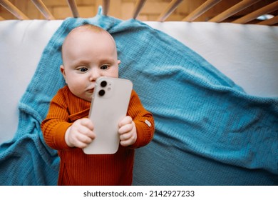 Baby toddler holding smartphone. Copy space. Graphic concept - Powered by Shutterstock