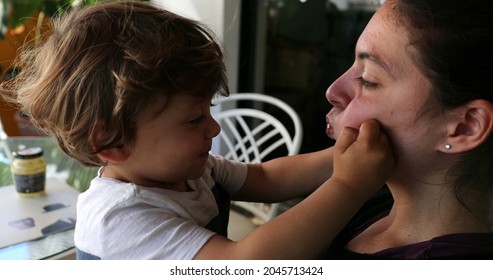 Baby Toddler Playing With Mother Cheeks, Casual Authentic Family Moment