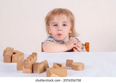 Baby Toddler Playing With Wooden Toys. He Hides One Of The Cubes. Does Not Want To Share A Toy