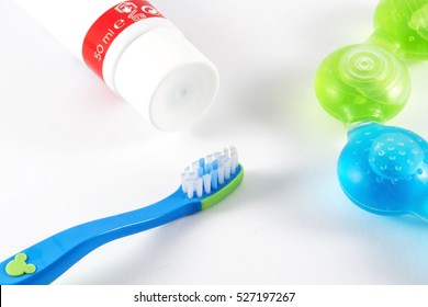 Baby Toothbrush And Toothpaste On White Background