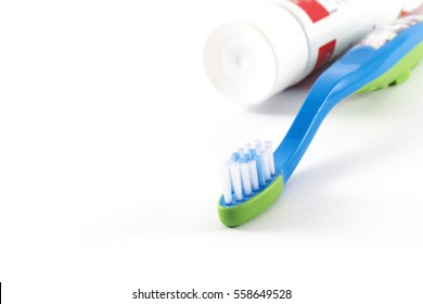 Baby Toothbrush And Toothpaste On White Background